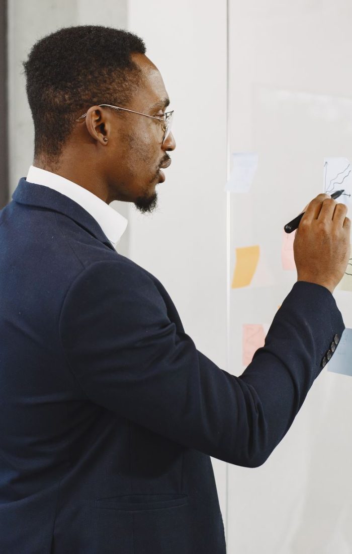 african-man-black-suit-man-writing-glass